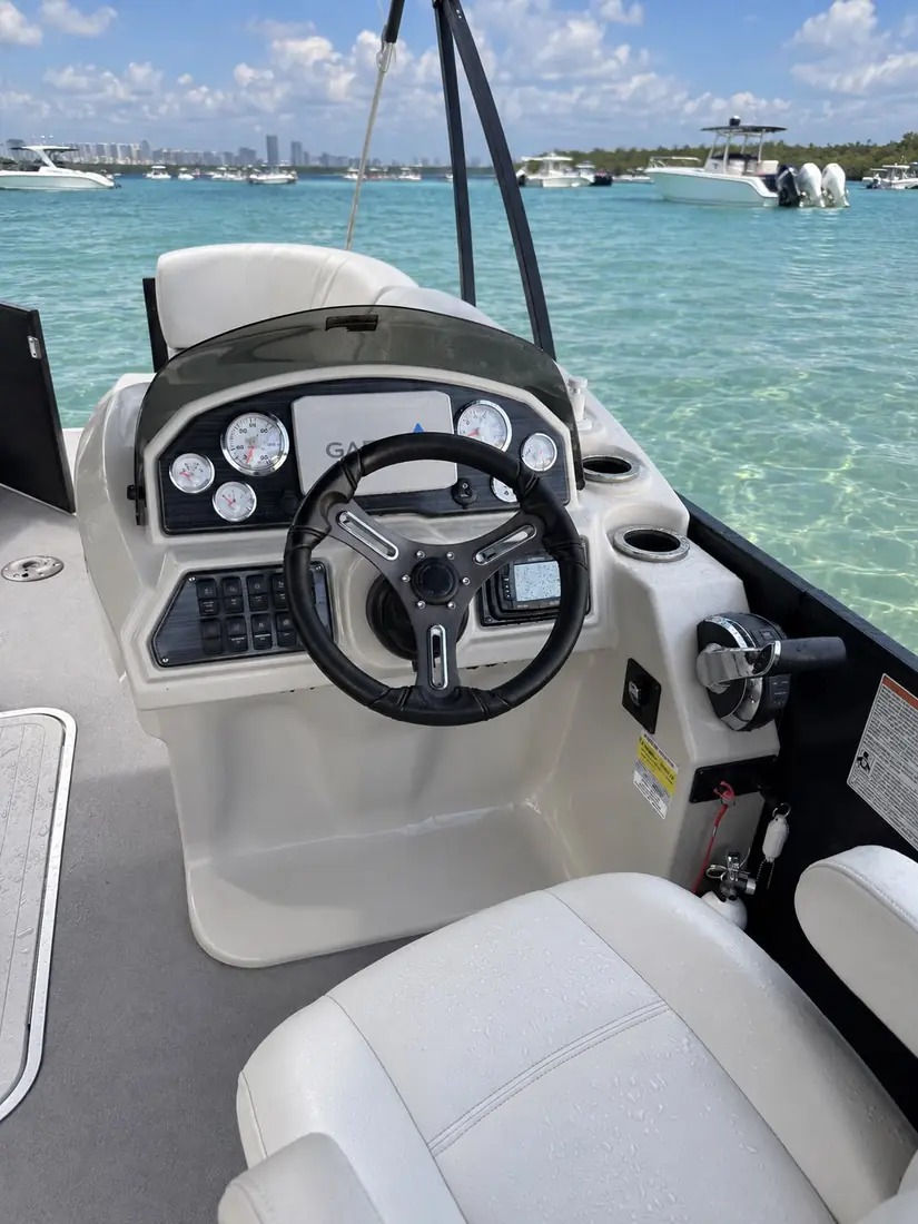 Captain's helm with steering wheel and Mercury gauges