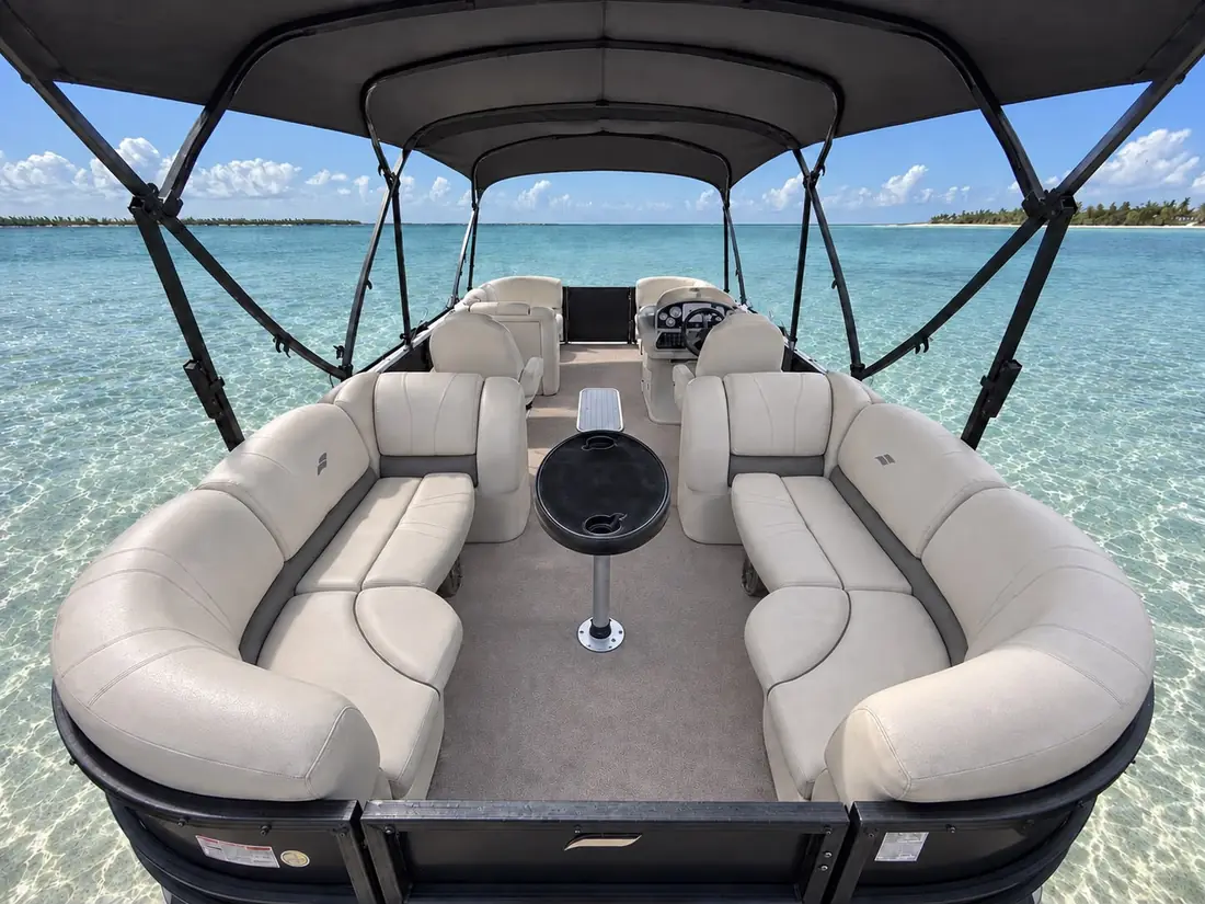 Rear lounge seating around the center table on the Starcraft pontoon