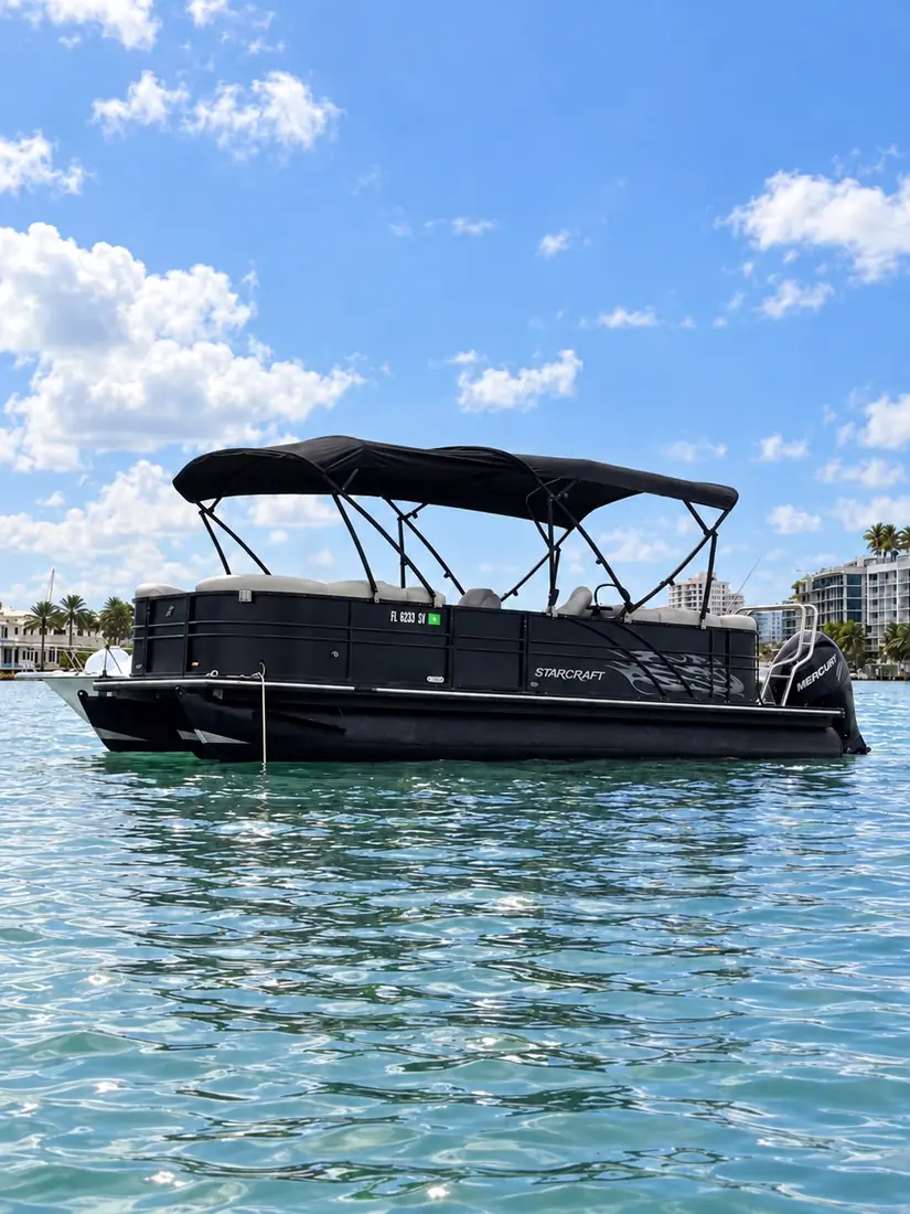 Starcraft pontoon side view on Biscayne Bay with the Miami skyline behind